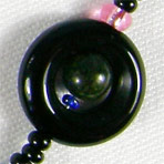 Black Saturn composed of black onyx and malachite elements
